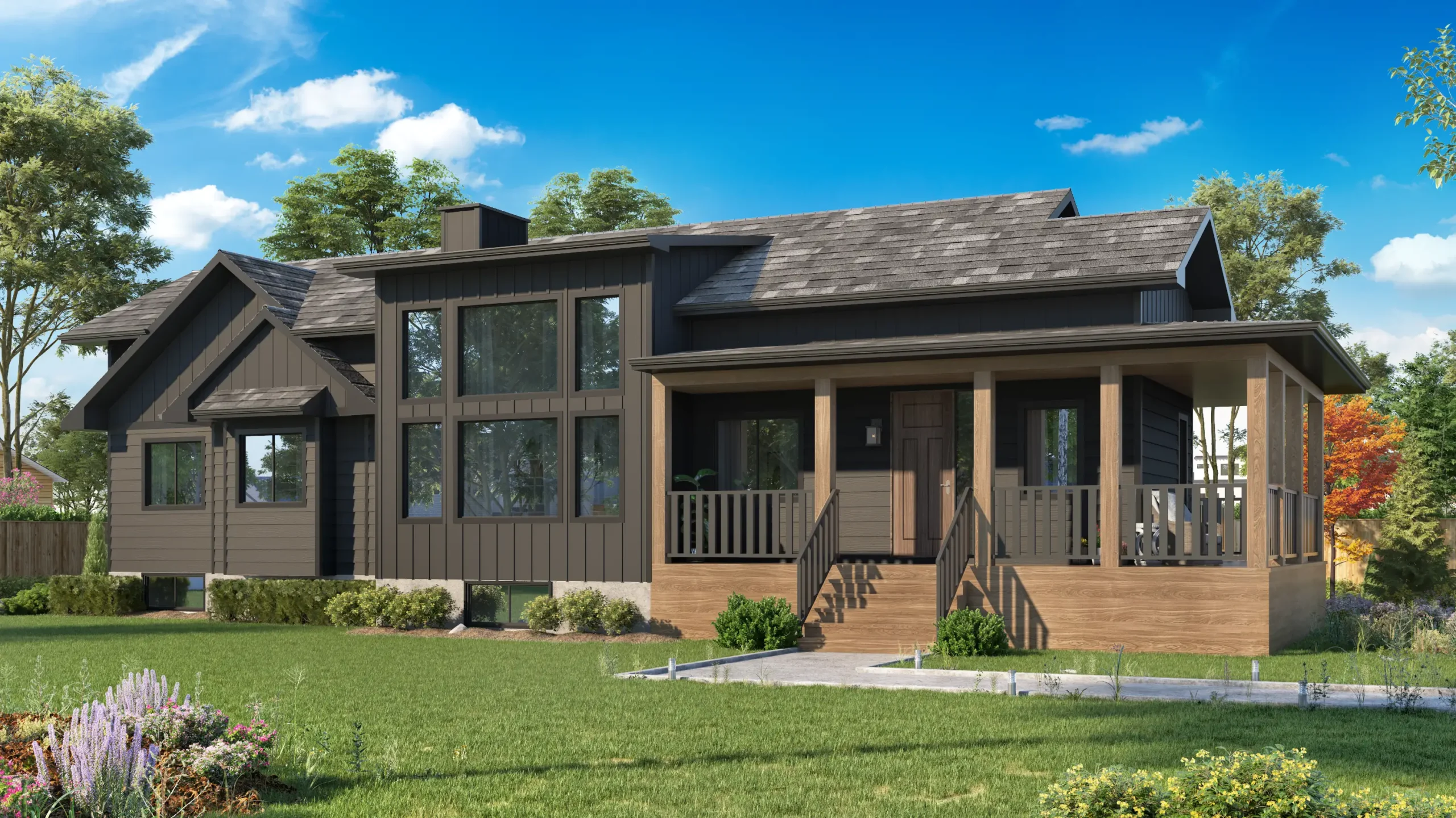 modern ready-to-move (RTM) home featuring dark wood siding with large windows, allowing ample natural light into the interior. The home includes a welcoming front porch with wooden pillars and railings, adding to its cozy, rustic appeal. The roof has a multi-gabled design, creating architectural depth and interest. The yard is landscaped with a green lawn, shrubs, and colorful flowers, providing a vibrant contrast to the dark exterior. The home is set against a backdrop of trees and a clear blue sky, enhancing the peaceful and inviting atmosphere.