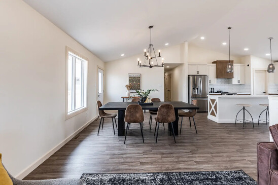 Open concept RTM home featuring dining room, kitchen island and stainless steel appliances in Alberta and Saskatchewan