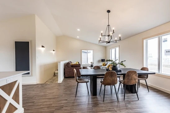 Open floor plan RTM home showing dining room and living area with vaulted ceiling in Alberta and Saskatchewan