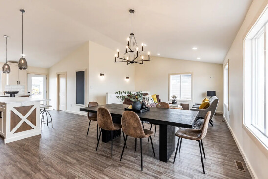 Modern RTM home interior with open kitchen, island seating and large dining area in Alberta and Saskatchewan