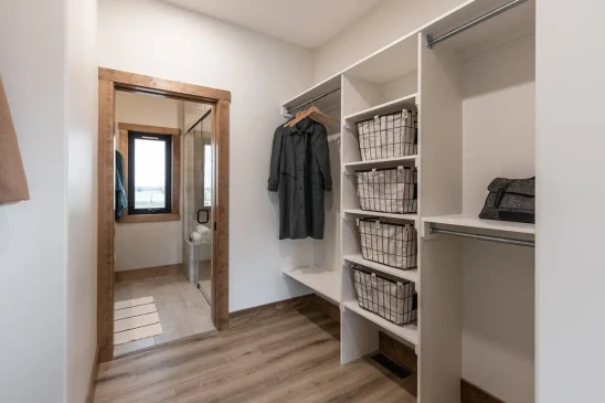 Walk-in closet and ensuite entry in RTM home with built-in shelving and wood trim, ready-to-move home in Alberta and Saskatchewan