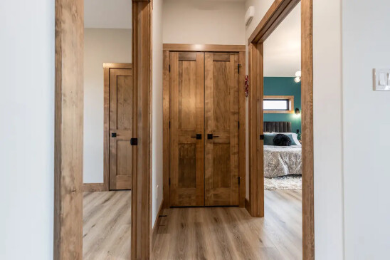 Interior hallway featuring solid wood doors and trim in custom RTM home in Alberta and Saskatchewan