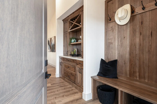 Custom built-in wood cabinetry with wine storage in RTM home entry area