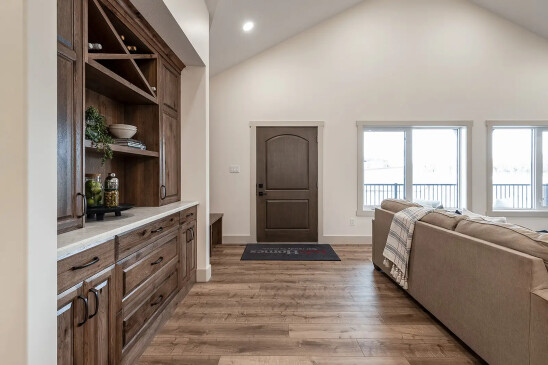 RTM home entryway with solid wood front door and built-in cabinet storage