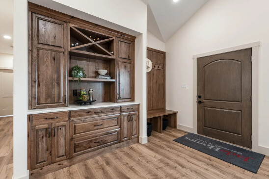 Rustic wood built-in hutch with wine rack and soft-close drawers in ready-to-move home